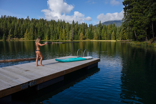 At dock edge. Forest and mountains in distance, Whistler, B.C.