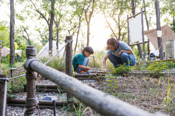 istock young Mom and son playing in the forest 1703116694