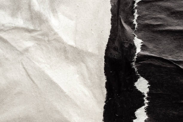 istock Old grunge ripped torn black paper poster surface texture background 1703118683