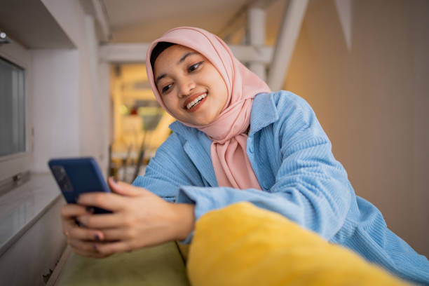 istock Happy young woman using phone 1703118684