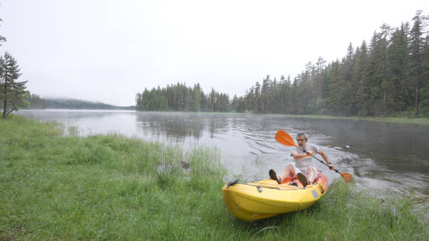 istock Solo traveler kayaking while camping in nature. 1703121001