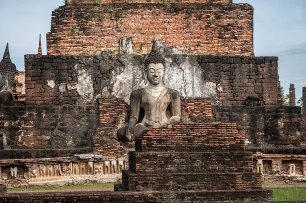 Photo of Beautiful Buddha statue in Wat Mahathat temple the most important and impressive temple compound in Sukhothai Historical Park.