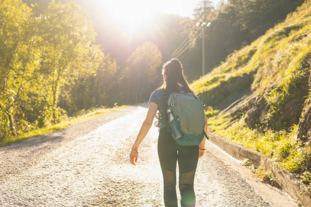 istock A young woman hiker walks along a rural trail during a nature walk 1703147907