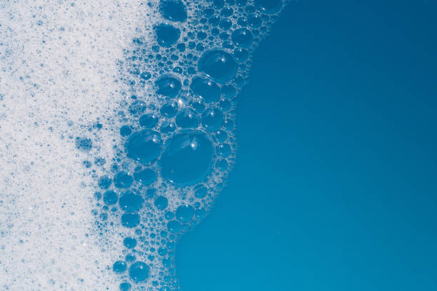 istock Detergent foam bubble on water. Blue background, Soap sud 1703156488