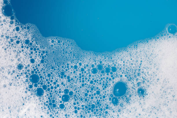 istock Detergent foam bubble on water. Blue background, Soap sud 1703157011