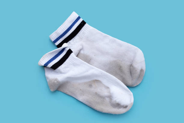 istock Dirty white socks on blue background. 1703165043