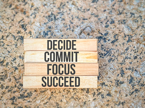 Inspirational motivational quote - decide commit focus succeed on wooden blocks