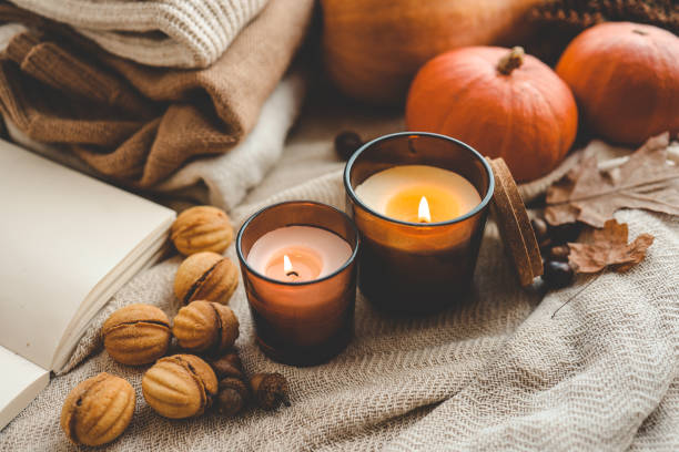 istock Two burning candles in the autumn interior 1703214451