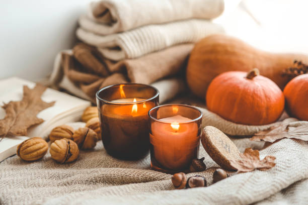 istock Two burning candles in the autumn interior 1703214456