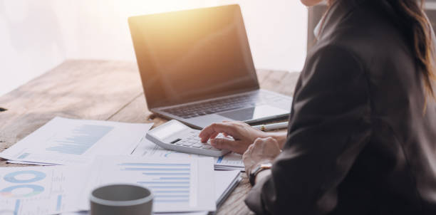 istock Close up bookkeepers working with balance sheet to analyze problems and find solutions to bringing develop business organization and company's stock market system. Common stock and preferred stock. 1703237009