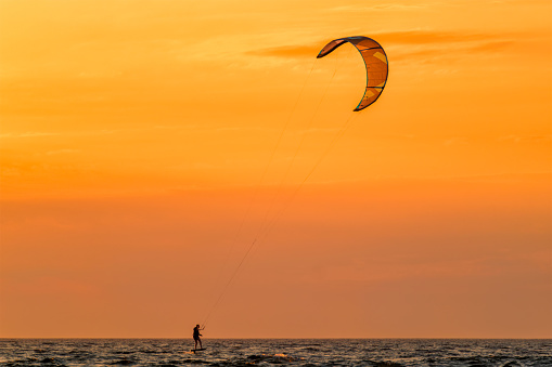 Toronto Ontario Canada \nPerson  kiteboarding in Toronto at Kew beach on Lake Ontario on a windy day