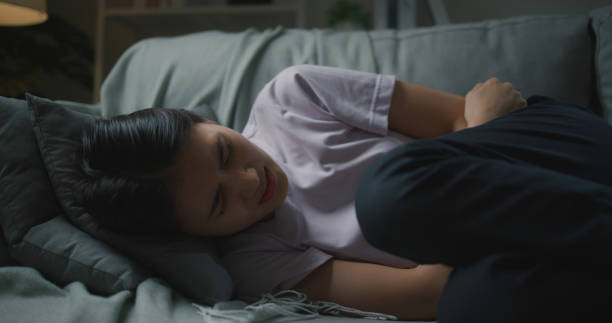 istock Depressed unhappy ill young Asian woman lying on couch 1703258657