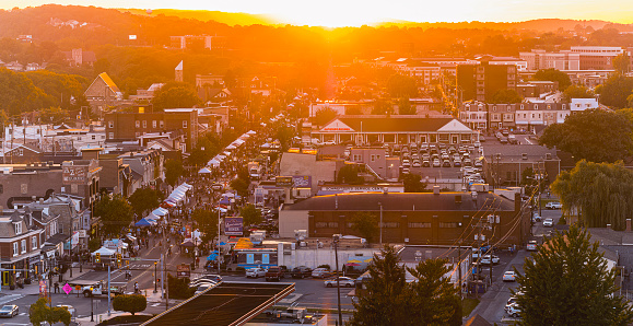 Fall Festival in West Reading, Pennsylvania: Blocked streets packed with food trucks and entertainment tents in sunny day. Aerial view