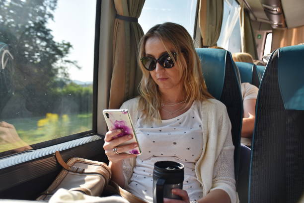 istock Woman sitting in the bus and using mobile phone 1703312467