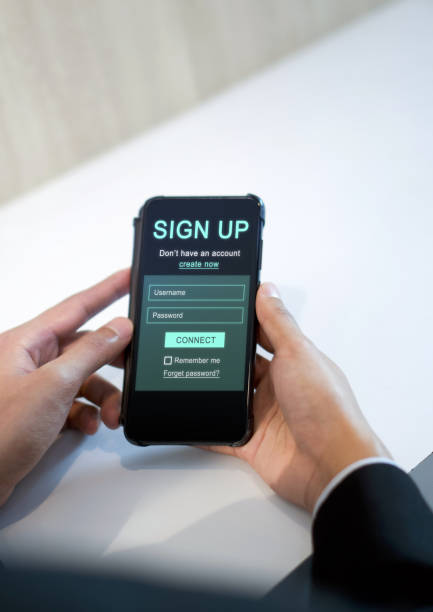 istock Digital Life Exploration. A focused man engrossed in creating his identity online, registering for an account on his smartphone. 1703340900