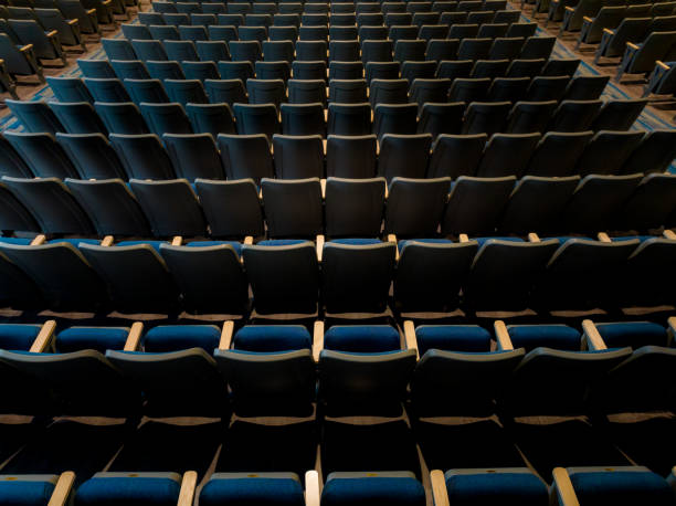 istock Overhead view of empty gray and blue theater, auditorium seats, chairs. 1703345103