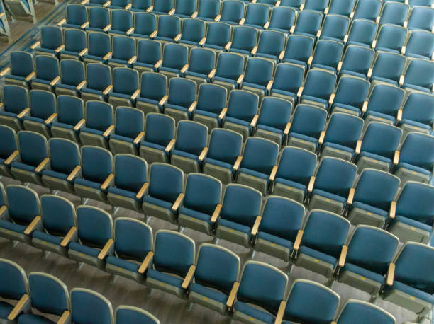 istock Overhead view of empty gray and blue theater, auditorium seats, chairs. 1703348885