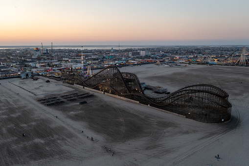 Large Wooden Roller Coaster at the Boardwalk in Wildwood, New Jersey at sunset.