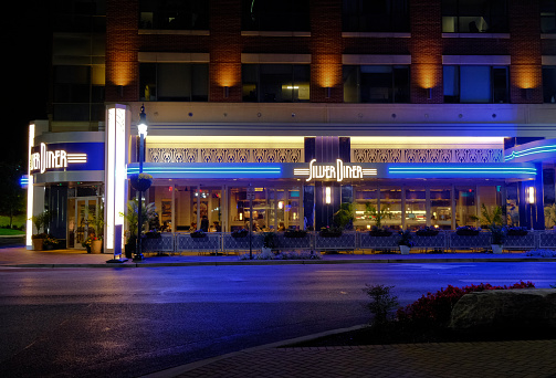 The Silver Diner Restaurant in National Harbor, Maryland is shown at nighttime.