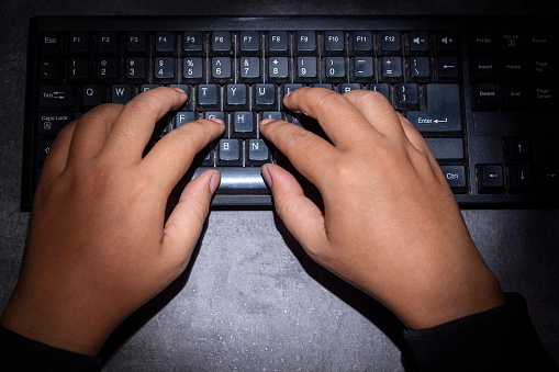 Hacker hand typing on a computer keyboard. Cyber Security concept