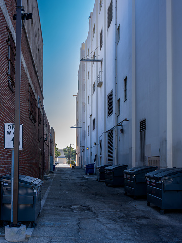 Large buildings highlight a narrow alley in an Urban area