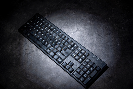 The computer keyboard with a dark background