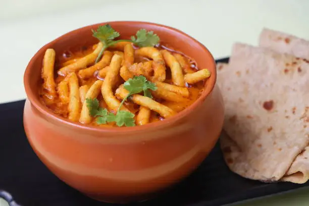 Photo of Shev bhaji or sev bhaji, a unique curry recipe made with the combination of spicy gathiya or fried besan noodles and curry from khandeshi kala masala, Maharashtrian food