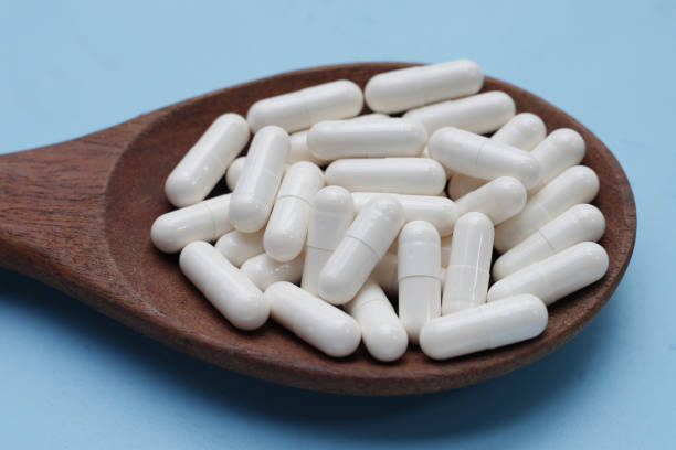 istock Medicine capsules on blue background. 1703407982