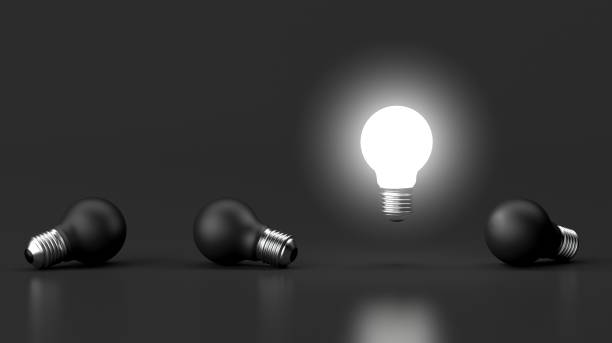 istock 3d illustration of brighten bulb outstanding from black bulb on dark background. 1703408539