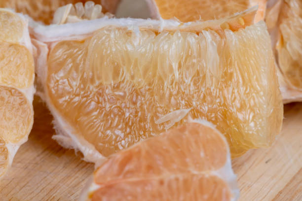 istock Freshly peeled pink pomelo on the table 1703410156