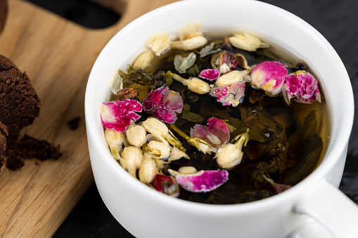 green tea with rose and jasmine flowers, cooked hot tea with the addition of dried red rose and jasmine flowers