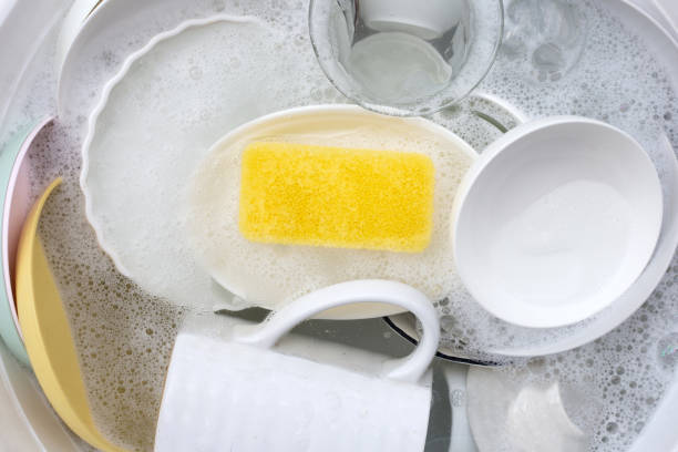 istock Dishes and bowls in water and bubbles of dishwashing liquid. Kitchen work 1703420691