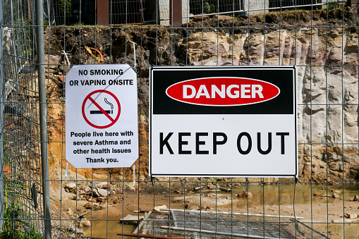 Warning signs on a fence around a construction site in Fairlight on the northern beaches of Sydney.  This image was taken on a sunny afternoon on 23 September 2023.