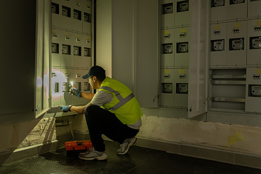 Male Technician Working At Electricity Power Station  During Power Outage