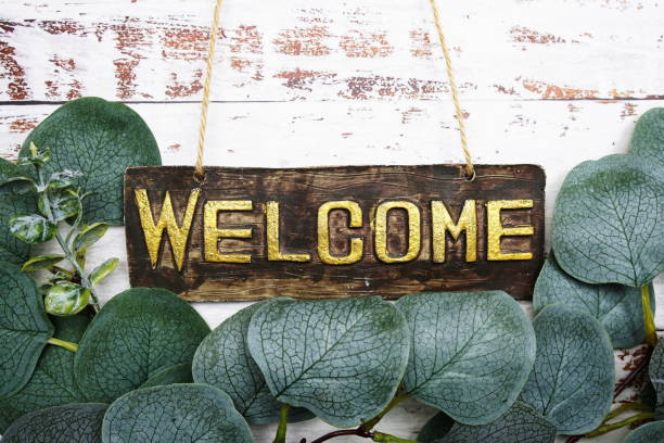 istock Welcome Sign with eucalyptus leaves frame decorate on wooden background 1703451262