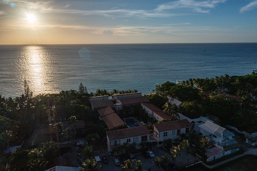 An aerial view of houses situated near the coast at sunset in Roatan Honduras