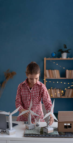 istock Pupil girl working on urban architecture project with renewable green energy source, alternative electricity 1703480690