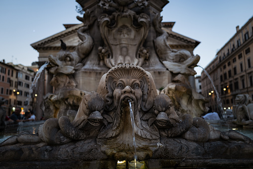 Rome, Italy- January 15, 2023: The Trevi Fountain at night, one of the largest monumental baroque fountains in the city of Rome, during a clear night with several tourist visiting