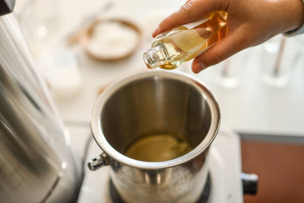 istock Woman pouring scent for candles, manufacturing process 1703540237
