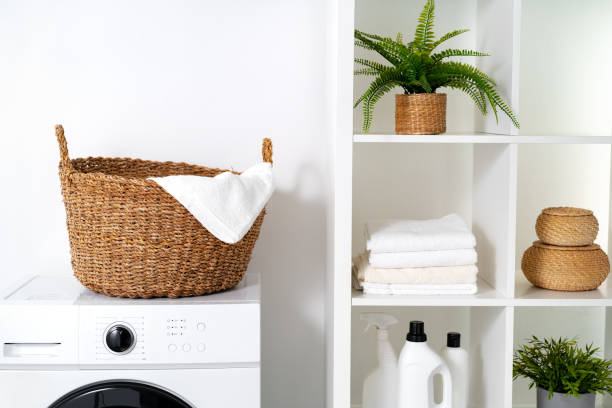 istock Laundry room with washing machine and basket with laundry 1703545896
