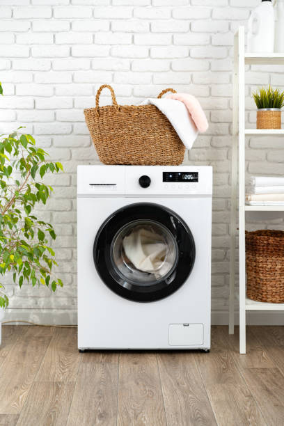 istock Laundry basket on washing machine in a laundry room 1703556870