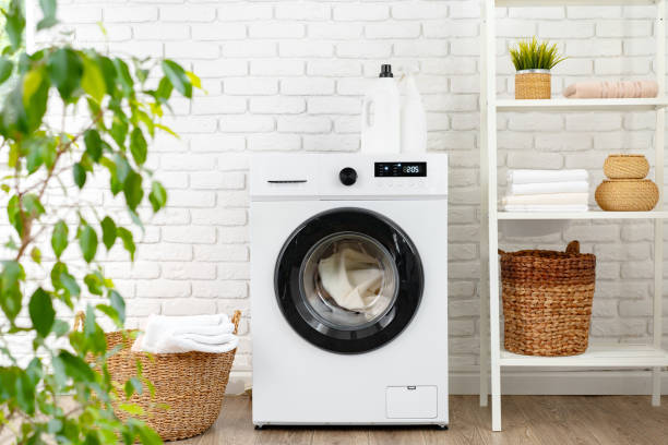 istock Washing machine and basket in a laundry room 1703556871