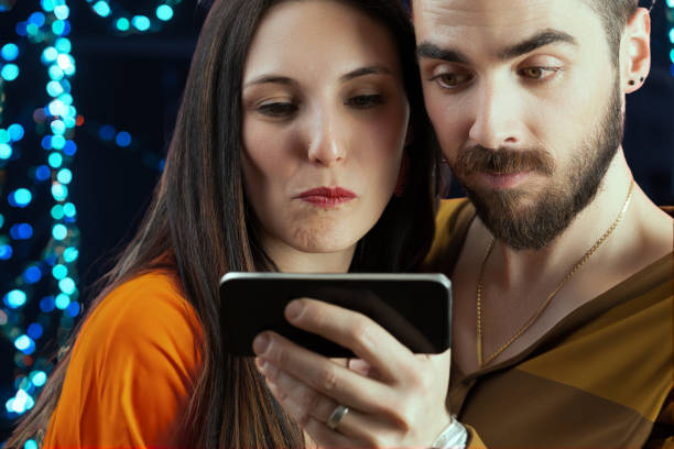 istock Couple joyously snaps selfie amidst vacation lights 1703561286
