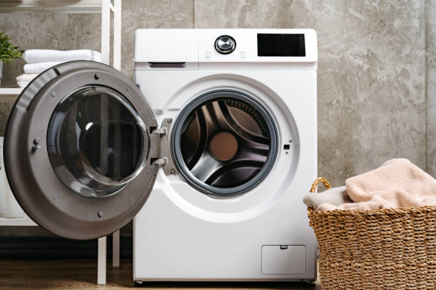 istock Washing machine in a gray modern laundry room 1703562391