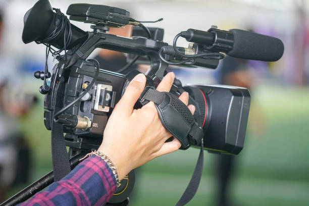 istock Holding the video camera, Press media working. 1703565587