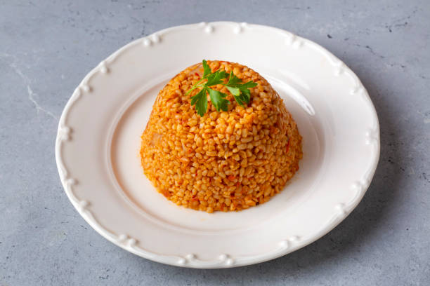 istock Traditional turkish bulgur pilaf with tomato sause in plate (Turkish name; meyhane pilavi) 1703568310