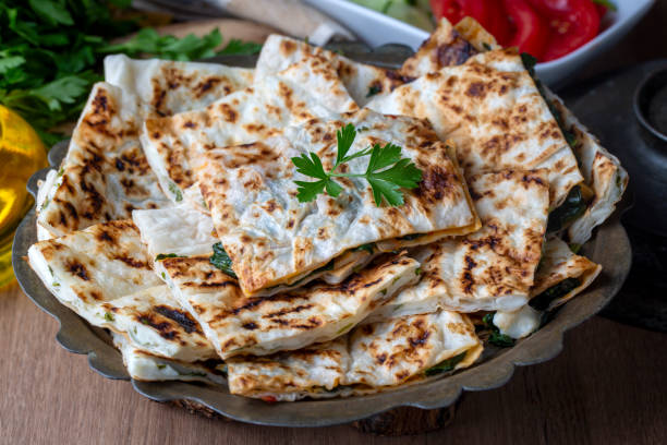 Traditional Turkish food, Turkish pancake gozleme with cheese and herb. The appetizer is Turkish pastry. There are varieties such as cheese, spinach, potato.