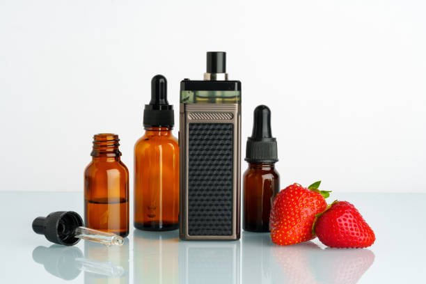istock Electronic cigarette liquid with strawberry flavor on white background 1703568902