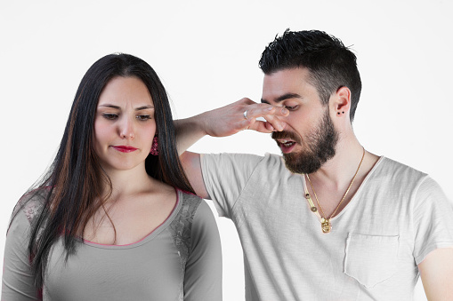 man and woman experience embarrassment from the smell of excessive sweating without deodorant. Notable visually and by smell, the stained armpit scenario emphasizes the importance of bodily hygi