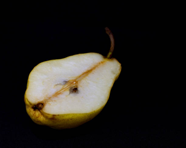istock part of a yellow pear lies on a black 1703576609